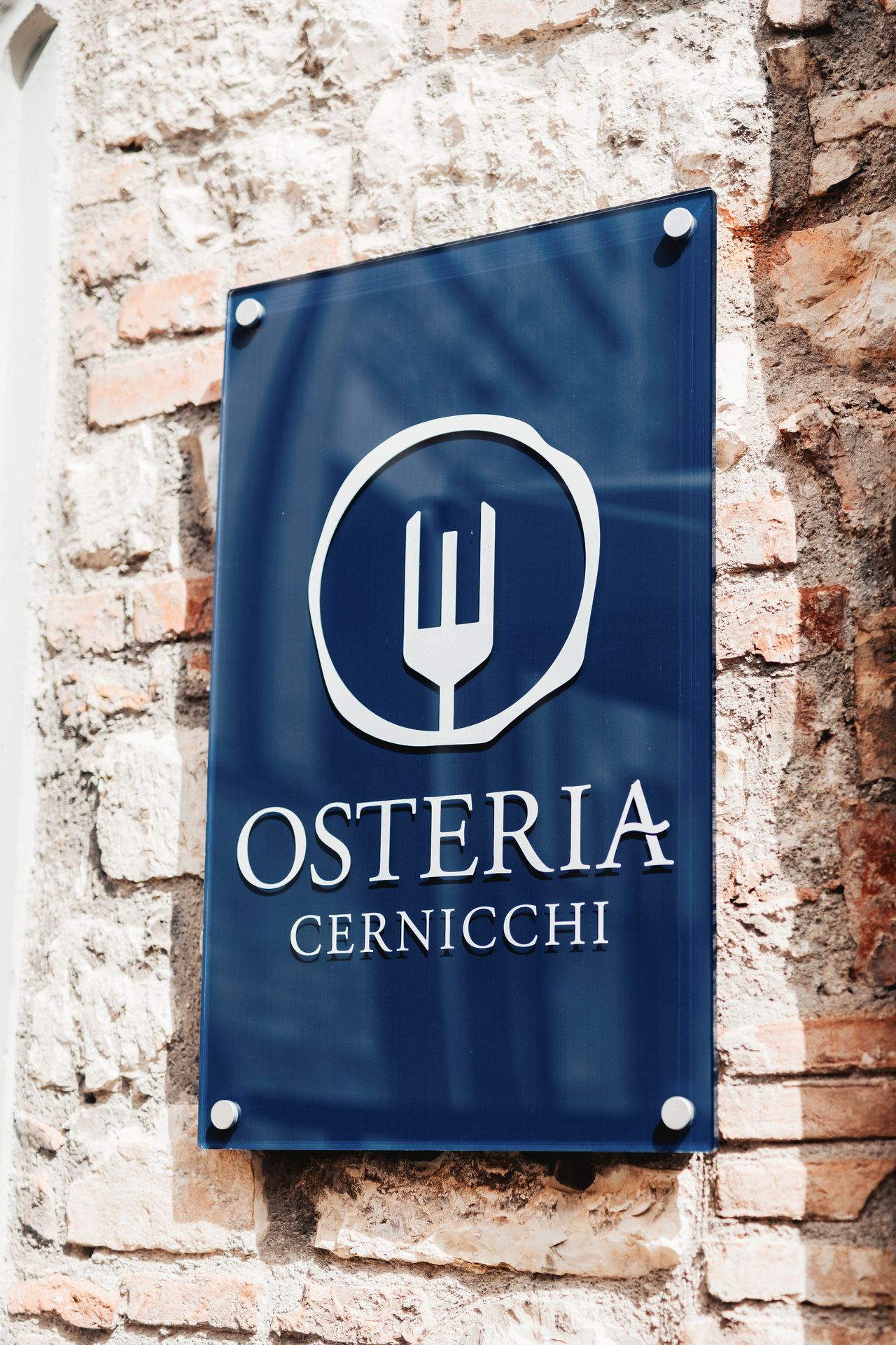 The Osteria Cernicchi sign on the stone wall