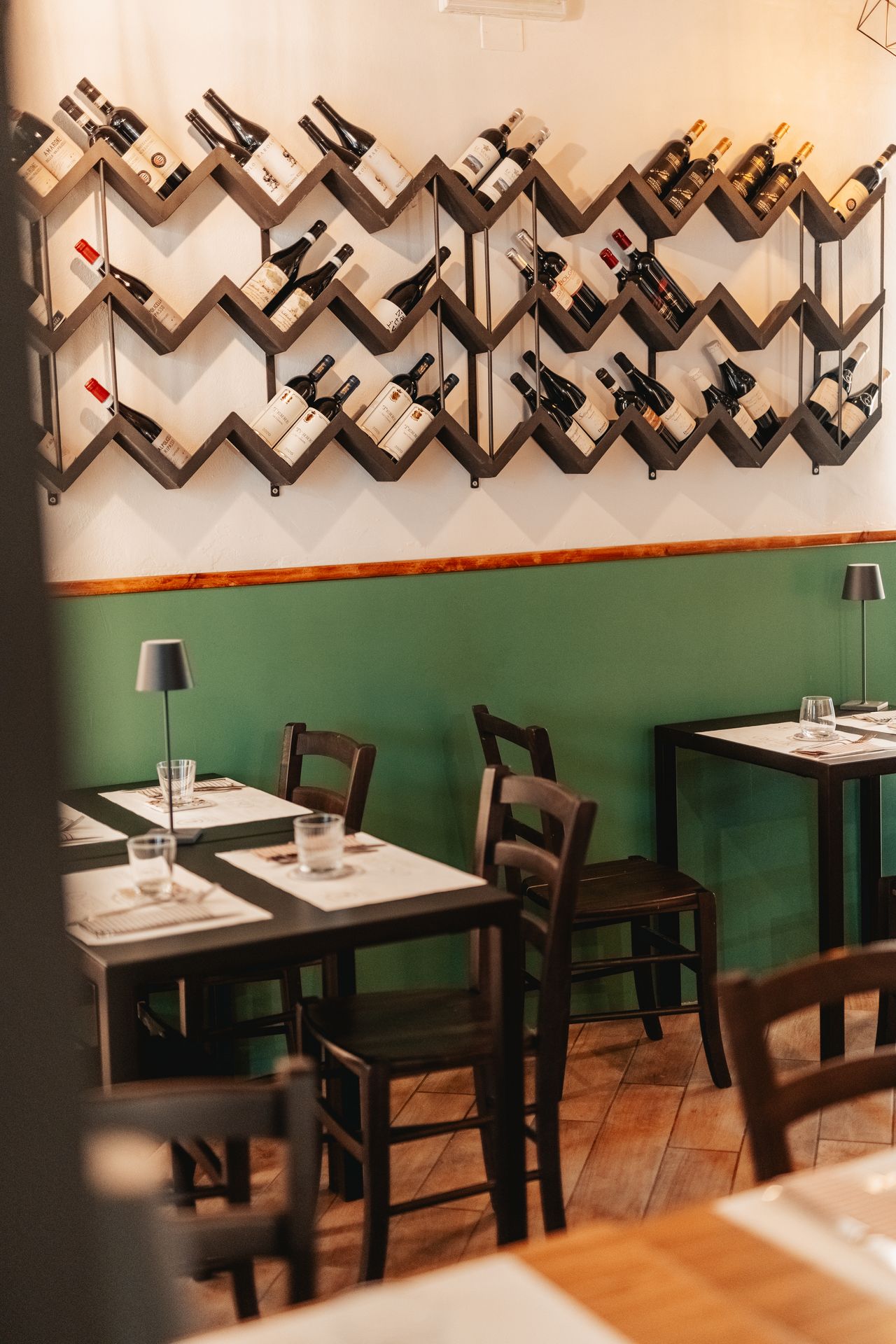 Tables in the dining room beside the wine wall