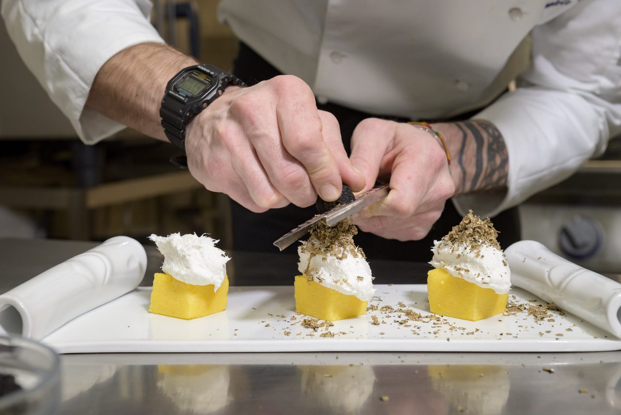 The chef shaves fresh truffle over a starter